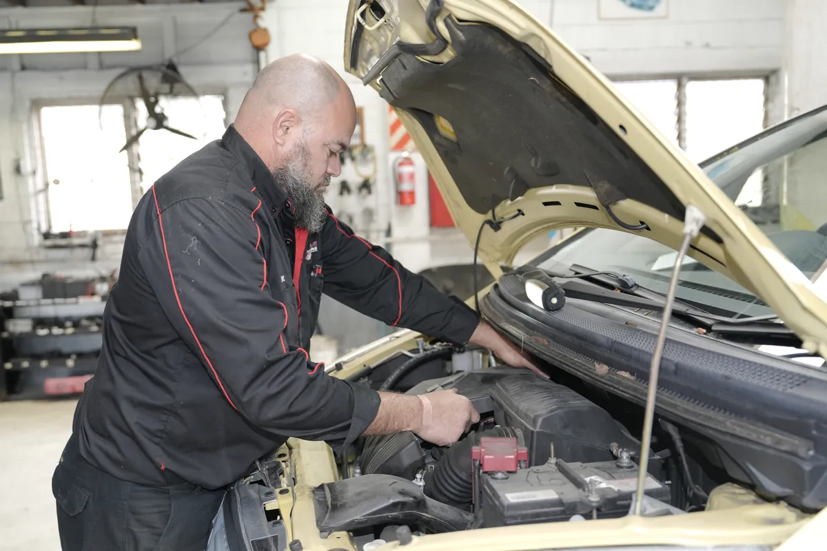 Checking engine electrics during a diagnostic at HM Motors, New Lynn